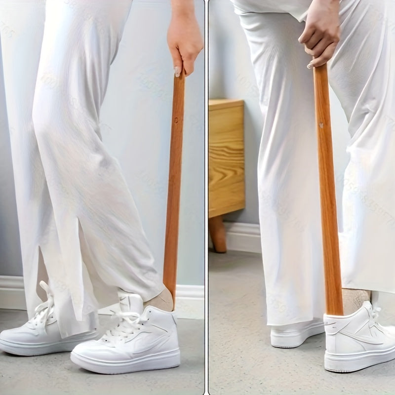 A wooden shoehorn with a long handle 