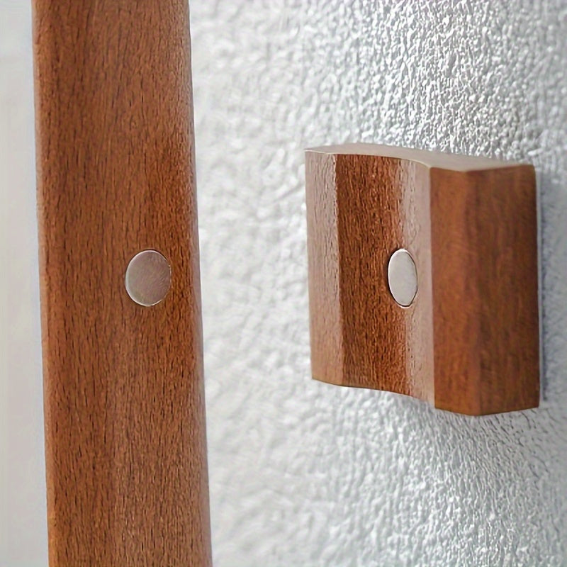 A wooden shoehorn with a long handle 